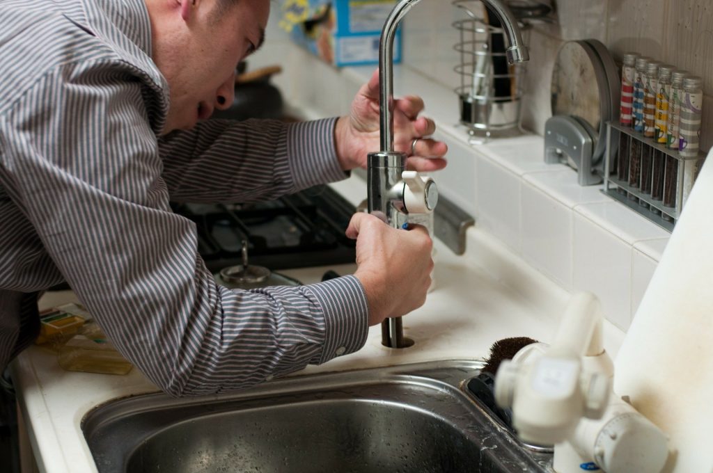 plumbing assisting resident with water leak