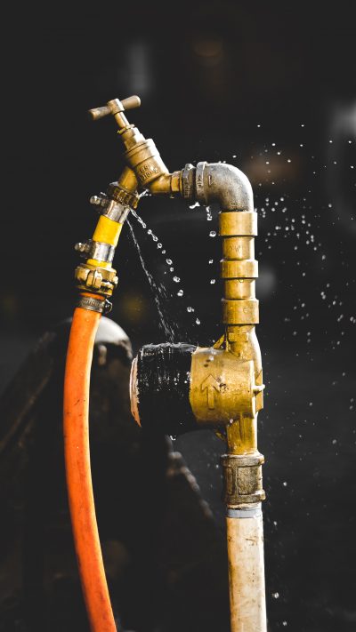 valentin-petkov-z06oDT-8pKQ-unsplash leaking pipe with orange hose